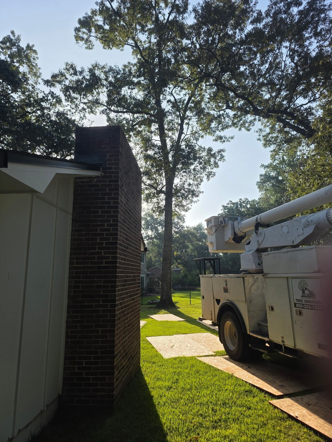 H&L bucket truck staged on protective yard mats